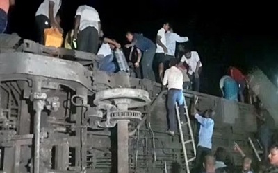 Locals gather after the Coromandel Express derails after hitting a goods train near Bahanaga station in Balasore on Friday